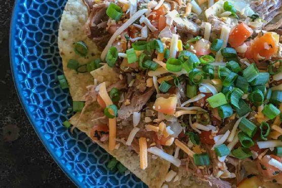 Epic Smoky Pulled Pork Nachos with Chipotle Lime Crema recipe by Meaghan Moineau