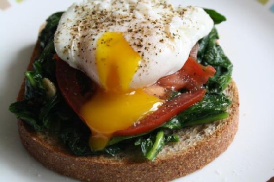 Truffle-Infused Poached Eggs with Spinach, Tomato, and Crispy Prosciutto recipe by Meaghan Moineau
